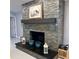 Living room with a stone fireplace and mantel, creating a warm and inviting atmosphere at 2380 Captain Butler Trl, New Smyrna Beach, FL 32168