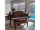 Living area featuring a piano and bench near the window, allowing for natural light to brighten the room at 2380 Captain Butler Trl, New Smyrna Beach, FL 32168