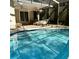 Sparkling swimming pool with covered patio and outdoor seating at 2380 Captain Butler Trl, New Smyrna Beach, FL 32168