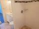 Bathroom with white tile shower, mosaic accents, and a vanity with storage at 101 N Riverside Dr # 2090, New Smyrna Beach, FL 32168