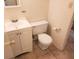 Bathroom featuring a white toilet, vanity, and neutral tile flooring at 101 N Riverside Dr # 2090, New Smyrna Beach, FL 32168