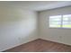 Bedroom with wood flooring, a window letting in natural light, and neutral paint at 101 N Riverside Dr # 2090, New Smyrna Beach, FL 32168