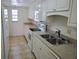 Bright kitchen featuring neutral counters, cabinets, and tile flooring at 101 N Riverside Dr # 2090, New Smyrna Beach, FL 32168