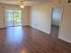 Spacious living room features wood floors, ceiling fan, and sliding doors to the balcony overlooking the water at 101 N Riverside Dr # 2090, New Smyrna Beach, FL 32168