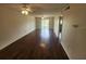 Generous living room featuring hardwood floors, ceiling fans, and multiple doorways at 101 N Riverside Dr # 2090, New Smyrna Beach, FL 32168
