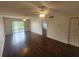 Spacious living room featuring hardwood floors, ceiling fans, and sliding glass doors at 101 N Riverside Dr # 2090, New Smyrna Beach, FL 32168