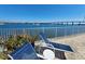 Outdoor patio area with lounge chairs, a table, and potted plants overlooking a scenic waterfront view at 101 N Riverside Dr # 2090, New Smyrna Beach, FL 32168
