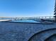 Community pool with beautiful views of water, boats and a bridge on a clear sunny day at 101 N Riverside Dr # 2090, New Smyrna Beach, FL 32168