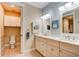 Bathroom featuring a double vanity with modern fixtures and a separate toilet room at 105 Azalea Cir, New Smyrna Beach, FL 32168