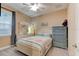 Comfortable bedroom with an area rug, ceiling fan, dresser, and white furniture at 105 Azalea Cir, New Smyrna Beach, FL 32168