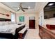 Beautiful bedroom featuring tray ceiling, fan, and detailed molding at 105 Azalea Cir, New Smyrna Beach, FL 32168