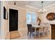 Elegant dining room with a chandelier, tray ceiling, and stylish decor at 105 Azalea Cir, New Smyrna Beach, FL 32168