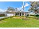 Charming single-story home featuring a well-manicured lawn and inviting front porch at 105 Azalea Cir, New Smyrna Beach, FL 32168