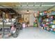 Spacious garage features ample storage shelving, a golf cart, and a clean, organized layout at 105 Azalea Cir, New Smyrna Beach, FL 32168