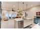 Beautiful kitchen with stainless steel appliances and an island that opens to the living area at 105 Azalea Cir, New Smyrna Beach, FL 32168