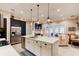 Open concept kitchen with a large island, stainless steel appliances, and view of the living room at 105 Azalea Cir, New Smyrna Beach, FL 32168