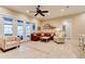 Bright living room with a large leather sofa and access to the outdoor patio at 105 Azalea Cir, New Smyrna Beach, FL 32168