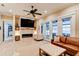 Cozy living room featuring a fireplace, television and french doors to the outside at 105 Azalea Cir, New Smyrna Beach, FL 32168