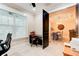 The office with natural light is shown, leading to the dining room with an elegant table and chandelier at 105 Azalea Cir, New Smyrna Beach, FL 32168