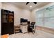Bright office space with a large window, built-in shelving, and a modern desk setup at 105 Azalea Cir, New Smyrna Beach, FL 32168