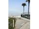 Pathway leading to a sandy beach with ocean views and blue skies at 1111 Hill St # U27, New Smyrna Beach, FL 32169