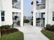 Exterior view of property with palm trees and gated access to amenities at 1111 Hill St # U27, New Smyrna Beach, FL 32169
