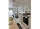 Bright kitchen with white cabinets and an open view into the living area at 1111 Hill St # U27, New Smyrna Beach, FL 32169