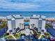 Aerial view of a beachfront property with a community pool, landscaping, and parking at 1275 Ocean Shore Blvd # 5050, Ormond Beach, FL 32176