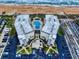 Aerial view of condo buildings, pool, beach access, and parking at 1275 Ocean Shore Blvd # 5050, Ormond Beach, FL 32176