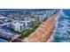 A picturesque aerial shot capturing the condos nestled along the pristine beachfront at 1275 Ocean Shore Blvd # 5050, Ormond Beach, FL 32176
