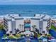 Aerial view of a beachfront condo complex, showcasing the building's architecture, pool, and ocean views at 1275 Ocean Shore Blvd # 5050, Ormond Beach, FL 32176