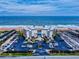 Aerial view of condo buildings, pool, beach access, parking, and ocean at 1275 Ocean Shore Blvd # 5050, Ormond Beach, FL 32176