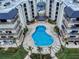 Unique aerial view of the pool area of the condos showcasing the pool and outdoor seating at 1275 Ocean Shore Blvd # 5050, Ormond Beach, FL 32176