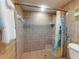 Shower stall featuring brown tile and modern fixtures at 1275 Ocean Shore Blvd # 5050, Ormond Beach, FL 32176