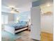 This bedroom features a queen bed, ceiling fan, closet, and calming wall art at 1275 Ocean Shore Blvd # 5050, Ormond Beach, FL 32176