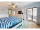 Bedroom showing balcony access, en-suite bathroom, and coastal decor at 1275 Ocean Shore Blvd # 5050, Ormond Beach, FL 32176