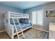 Light and airy bedroom with bunk beds, a patterned rug, and plantation shutters at 1275 Ocean Shore Blvd # 5050, Ormond Beach, FL 32176