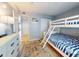 Bunk bed bedroom with a large dresser and view to the rest of the condo unit at 1275 Ocean Shore Blvd # 5050, Ormond Beach, FL 32176