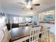 Open-concept dining room with wood table, seating for six, and access to the living room at 1275 Ocean Shore Blvd # 5050, Ormond Beach, FL 32176