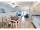 Coastal style dining room with seating for six and a view of the living room and balcony at 1275 Ocean Shore Blvd # 5050, Ormond Beach, FL 32176