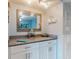 Hallway bar area with extra counter space and cabinet storage featuring beach-themed decor at 1275 Ocean Shore Blvd # 5050, Ormond Beach, FL 32176