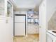 Bright kitchen with all white appliances and cabinetry flows seamlessly into other living areas at 1275 Ocean Shore Blvd # 5050, Ormond Beach, FL 32176