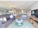 Bright living room featuring two sofas, mirrored wall, and open access to the dining and kitchen areas at 1275 Ocean Shore Blvd # 5050, Ormond Beach, FL 32176