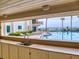 View from the outdoor kitchen cabana overlooking the pool and the ocean in the distance at 1275 Ocean Shore Blvd # 5050, Ormond Beach, FL 32176