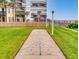 Enjoy outdoor recreation with this shuffleboard court amid lush lawn, palm trees, and a view of the condo building at 1275 Ocean Shore Blvd # 5050, Ormond Beach, FL 32176