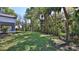 Expansive backyard featuring lush lawn, mature trees and access to creek at 1350 Scarlett Trl, New Smyrna Beach, FL 32168