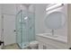 Modern bathroom boasts a glass-enclosed shower and elegant vanity with ample light at 1350 Scarlett Trl, New Smyrna Beach, FL 32168