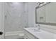 Bathroom featuring a new vanity, sink, and tiled shower with marble accents at 1350 Scarlett Trl, New Smyrna Beach, FL 32168