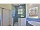 Stylish bathroom featuring tiled shower with frameless glass enclosure and window view at 1350 Scarlett Trl, New Smyrna Beach, FL 32168