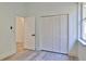 Bright bedroom featuring wood-look tile flooring, a window, and a closet at 1350 Scarlett Trl, New Smyrna Beach, FL 32168